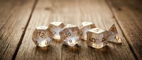 Set of translucent polyhedral gaming dice on rustic wooden table surface for tabletop role-playing games and board game entertainment.