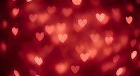 Romantic red bokeh background with soft glowing heart shapes for Valentine's Day celebrations, wedding invitations, and love-themed designs.