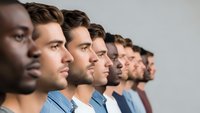 Diverse group of men in profile view showing multicultural teamwork and unity in modern workplace setting.