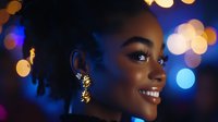 Young African American woman with natural hair smiling against blurred bokeh lights background in blue and gold tones, radiating joy and confidence.