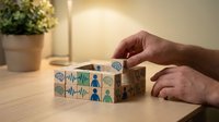 Human resources manager assembling wooden blocks with employee icons for team building and organizational development in modern office setting.