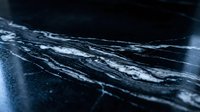 Cracked broken glass surface with sharp fragments and spider web pattern damage on dark background for safety and accident concepts.