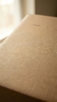 Close-up of natural brown kraft paper texture with soft lighting and shallow depth of field for packaging and craft projects.