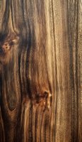 Rich brown wooden texture with natural grain pattern and knots, showcasing warm tones and organic striations for furniture design or interior backgrounds.