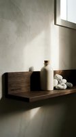 Minimalist wooden shelf with ceramic bottle and decorative stones against textured wall with natural light, suitable for home decor and interior design projects.