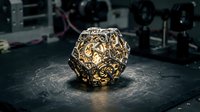 Golden ornate polyhedral dice with intricate filigree patterns on dark surface, suitable for tabletop gaming, fantasy content, and design projects.