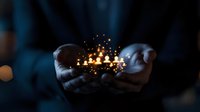 Businessman hands cupping glowing magical light particles in dark office environment symbolizing innovation creativity and digital transformation concepts.