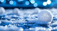 Frozen soap bubble with crystallized patterns on snow surface against blurred blue bokeh background creates magical winter atmosphere.