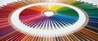 Colored pencils arranged in circular rainbow spectrum pattern with white center, displaying full chromatic range from red through violet for art, design, and creative projects.