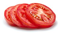 Fresh sliced red tomato arranged in a row showing juicy interior with seeds and gel chambers on white background, ready for culinary use.