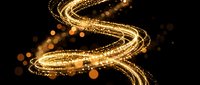 Golden light trails swirling in elegant curves with sparkling particles and bokeh effects on black background for luxury design projects.