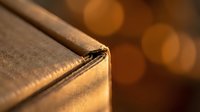 Close-up of vintage leather-bound book with golden warm bokeh lights in background creating cozy atmospheric reading environment for literature and education.