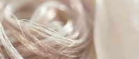 Closeup of silky blonde hair strands with soft focus background, suitable for beauty, haircare, and wellness marketing materials.