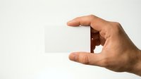 Hand gesture showing small measurement between thumb and index finger on white background for size comparison concepts.