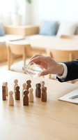 Business hand protecting wooden people figures with glass shield symbolizing employee protection, insurance coverage and corporate responsibility in office.