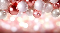 Festive red and white Christmas baubles on blurred bokeh background with soft glowing lights creating magical holiday atmosphere. Suitable for seasonal designs.