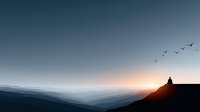 Silhouette of person sitting on mountain peak watching sunrise over layered hills with birds flying in peaceful morning sky for meditation and wellness content.