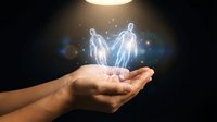 Glowing holographic human figures floating above open palm with magical light effects and sparkles against dark background for digital concepts.