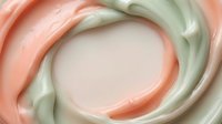 Soft pastel swirls of coral and sage green blend together in fluid, organic motion creating an abstract circular composition with smooth, creamy texture.