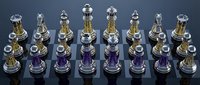 Elegant glass chess set with translucent pieces in gold and purple colors arranged on dark surface for strategic board game competition.