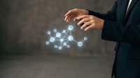 Businessman in dark suit holding glowing network connection nodes, representing digital technology, data integration, and business connectivity solutions.