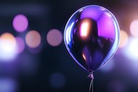 Metallic purple balloon floating on blurred bokeh background with dreamy atmosphere and soft lighting effects. Celebration concept with festive mood.