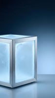Modern refrigerator with frosted glass doors and metallic frame against blue gradient background. Suitable for appliance advertising, kitchen design concepts, and product showcases.