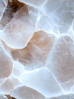 Pink salt crystal macro photography showing natural mineral texture and translucent layers with white veining patterns and light refraction effects.