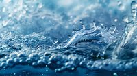 Dramatic water splash macro photography with crown-shaped liquid formation against blue background, featuring crystal clear droplets and dynamic motion blur.