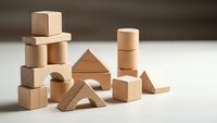 Natural wooden building blocks arranged on white surface for educational play and creative construction activities.