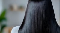 Silky smooth black straight hair from back view showing healthy shine and professional salon treatment results. Asian woman with long dark glossy hairstyle.