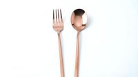 Rose gold fork and spoon set isolated on white background, elegant copper-toned cutlery for modern dining, kitchen, and restaurant menu design.