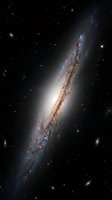 Spectacular edge-on spiral galaxy with bright central bulge and dark dust lanes against starfield background for astronomy and space science projects.