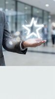 Businessman in gray suit holding glowing neon star icon in palm, representing excellence, success, and quality rating in modern corporate environment for business concepts.
