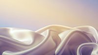 Flowing silk fabric with soft pastel gradient background creates elegant abstract composition for luxury design projects and feminine branding materials.
