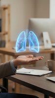 Holographic lungs floating above open palm in modern office setting for healthcare technology and medical innovation concepts.