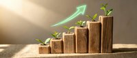 Wooden blocks arranged as ascending bar chart with green plants sprouting from each level and glowing growth arrow, symbolizing sustainable business progress.