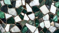 Geometric mosaic pattern in emerald green and white marble pieces creating abstract background texture with irregular shapes and metallic grout lines.