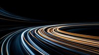 Dynamic curved light trails in blue, white and orange streaking through darkness create abstract motion effect on black background. Suitable for technology concepts.