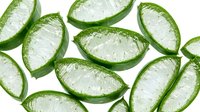 Sliced cucumber halves with water droplets on white background, isolated for culinary design, food packaging, and recipe graphics.