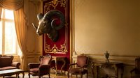Ornate palace interior with golden walls, red velvet chair, and mounted ram head sculpture, suitable for luxury design and historical decor projects.