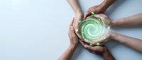 Hands forming protective circle around glowing green energy spiral symbolizing teamwork, unity, environmental protection and sustainable collaboration concept.