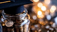 Stack of coins in glass jar topped with graduation cap against blurred golden bokeh lights, symbolizing education savings and financial planning for college studies.