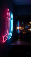 Vibrant pink and blue neon lights illuminating dark interior space creating atmospheric glow for nightlife entertainment venue design and urban aesthetic.
