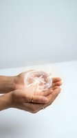 Hands holding glowing transparent light bulb with bright filament against clean white background representing innovation and creative ideas for business concepts.
