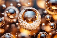 Macro photography of golden water drops with air bubbles creating abstract pattern. Artistic close-up shows light refraction and surface tension in warm tones.