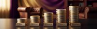 Growing stacks of golden coins arranged in ascending order representing financial growth, investment success, and wealth accumulation in warm lighting.