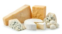 Assorted cheese varieties including aged cheddar, blue cheese, mozzarella balls and soft cheese wheels isolated on white background for food, culinary and dairy product design use.