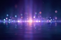 Magical purple and blue bokeh lights reflecting on water surface with glowing rays and particles creating dreamy atmospheric background.
