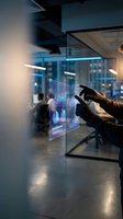 Businessman analyzing financial data on futuristic holographic display in modern office environment for business intelligence and data visualization.